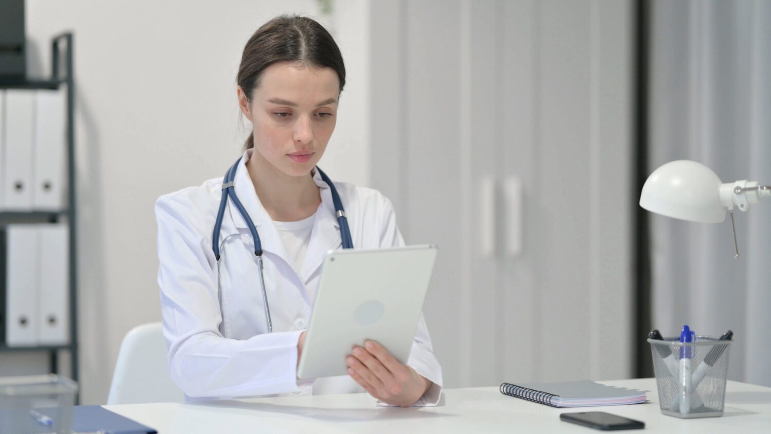 Female Doctor using Tablet in Clinic