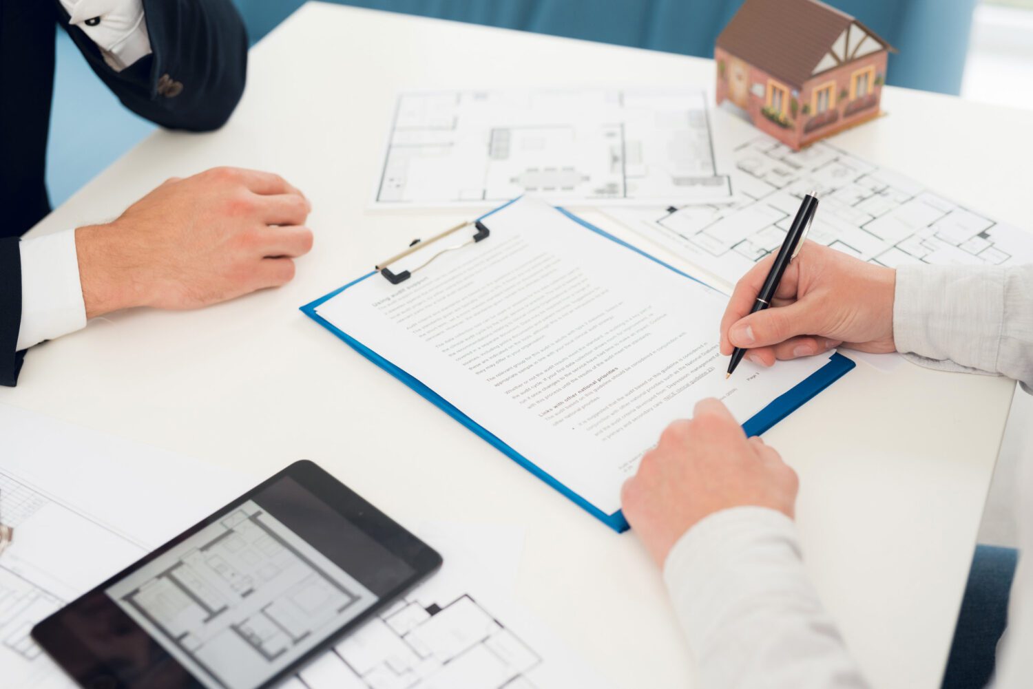 Conclusion of a contract for purchase of draft with realtor. Close-up photo of contract and draft.